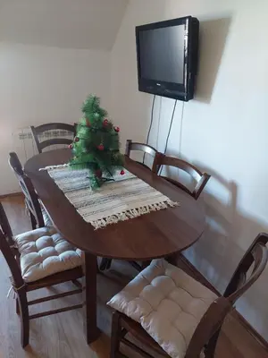 a dining room table with a christmas tree on it at JollyKop Vila Valentina A14 in Kopaonik