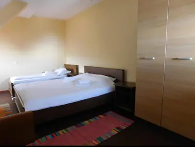 a hotel room with a bed and a closet at JollyKop Vila Valentina A14 in Kopaonik