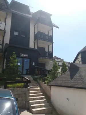 a large house with stairs in front of it at JollyKop Vila Valentina A14 in Kopaonik