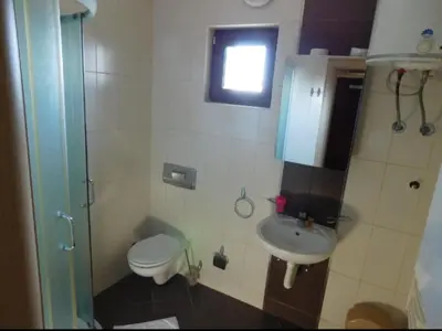 a small bathroom with a toilet and a sink at JollyKop Vila Valentina A14 in Kopaonik