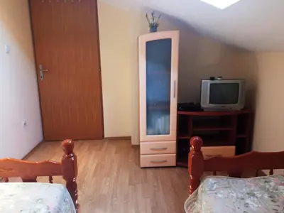 a bedroom with a bed and a tv and a dresser at Apartman Babić in Vrnjačka Banja