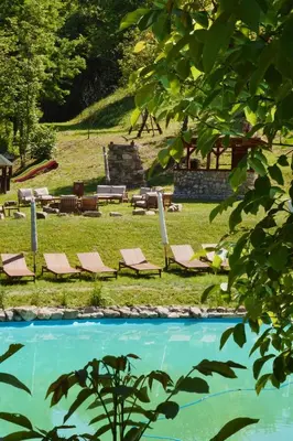 a group of lounge chairs and a swimming pool at Eko Zaseok Brana in Rekovac