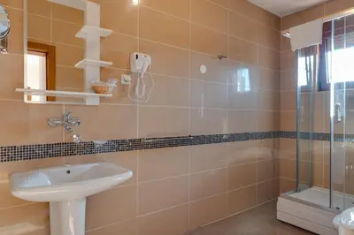 a bathroom with a sink and a shower at DolceVita Lux & SPA in Vrnjačka Banja