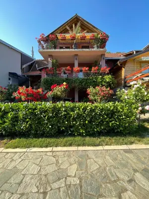 a house with flowers on the side of it at Apartman Jovanović in Jošanička Banja