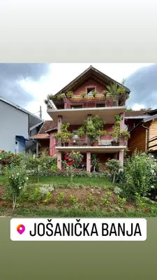 a building with a balcony with plants on it at Apartman Jovanović in Jošanička Banja
