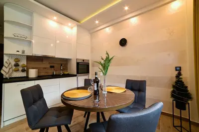 a kitchen and dining room with a table and chairs at Tontic Lux Milmari in Kopaonik