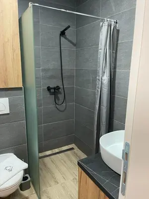 a bathroom with a shower and a toilet and a sink at Tontic Lux Residence Hill 53 in Kopaonik