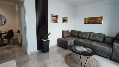a living room with a couch and a table at Lux Apartman Crnjanski IV, Jagodina in Jagodina