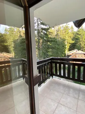 a balcony of a house with a view of trees at Apartman Zvončica 29 in Kopaonik