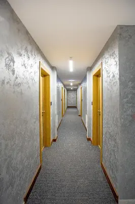 a corridor of an office building with yellow doors at Vila Bela reka in Brzeće