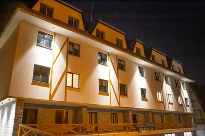 a building with lights on the side of it at Vila Bela reka in Brzeće