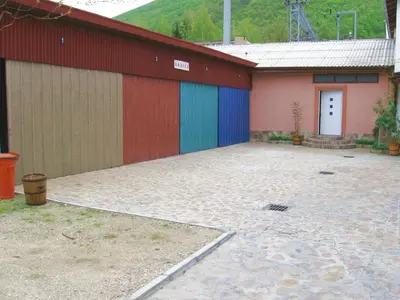 a building with colorful doors and a driveway at Amfora Rooms Caribrod in Dimitrovgrad