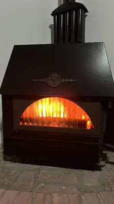 a fireplace with a fire in it at Vila Vida in Kruševac