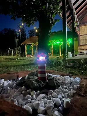 a lighthouse in a rock garden at night at Vila Vida in Kruševac