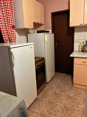 a kitchen with two refrigerators and a stove at Vila Vida in Kruševac