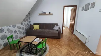 a living room with a couch and a table at BeoKop Apartment in Brzeće