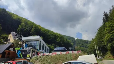 a road with cars parked on the side of a mountain at BeoKop Apartment in Brzeće