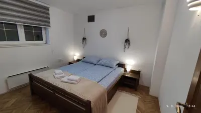 a small bedroom with a bed and a window at BeoKop Apartment in Brzeće