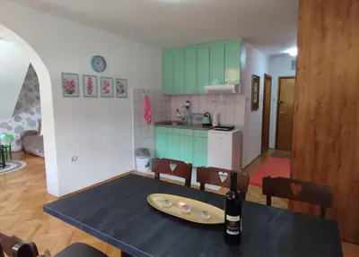 a kitchen with a table with a surfboard on it at BeoKop Apartment in Brzeće