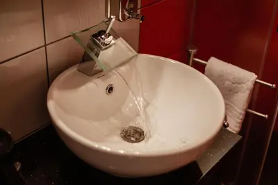 a white sink in a bathroom with a fosset at Stan na dan Premium 030 in Bor