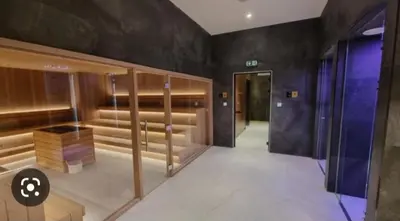 a dressing room with wooden benches and a hallway at WOODSIDE - Luxury Apartment & SPA in Kopaonik