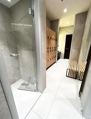 a bathroom with a walk in shower and a glass door at WOODSIDE - Luxury Apartment & SPA in Kopaonik