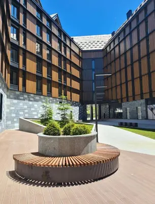 a large building with two planters in front of it at WOODSIDE - Luxury Apartment & SPA in Kopaonik