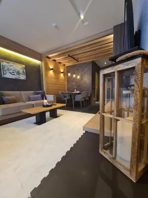 a living room with a couch and a table at WOODSIDE - Luxury Apartment & SPA in Kopaonik