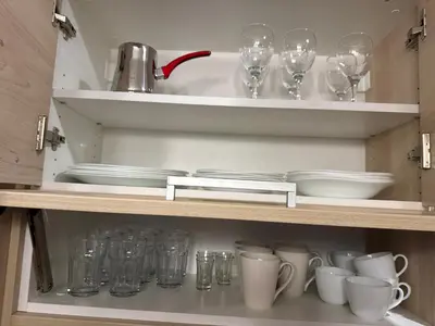 a cupboard filled with glasses and plates and dishes at Vila Zvončica Apartman Z12 in Kopaonik