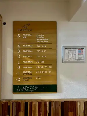 a menu on the wall of a restaurant at Vila Zvončica Apartman Z12 in Kopaonik