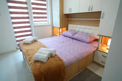 a bedroom with a bed with towels on it at SokoPan in Soko Banja