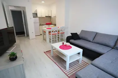 a living room with a couch and a table at SokoPan in Soko Banja