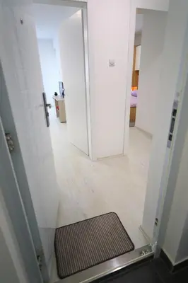 a hallway with a door and a mat in a room at SokoPan in Soko Banja