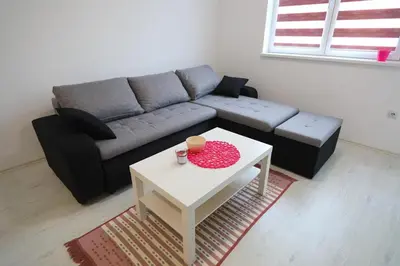 a living room with a couch and a table at SokoPan in Soko Banja