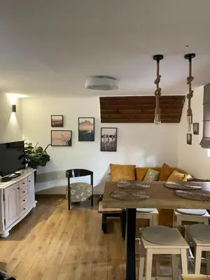 a living room with a table and a couch at Kućerak na Kopu in Kopaonik