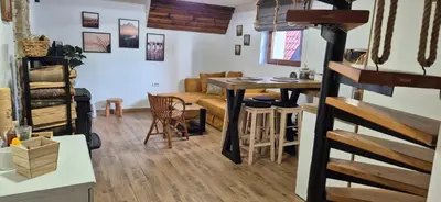 a living room with a table and a couch at Kućerak na Kopu in Kopaonik