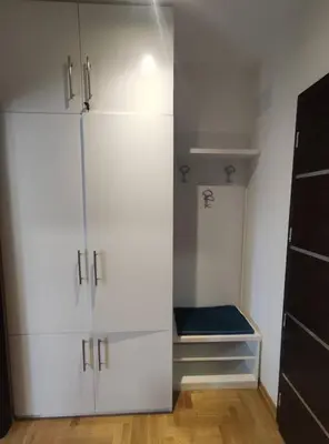 a closet with white cabinets in a room at Apartman S16 Vrnjačka Banja in Vrnjačka Banja