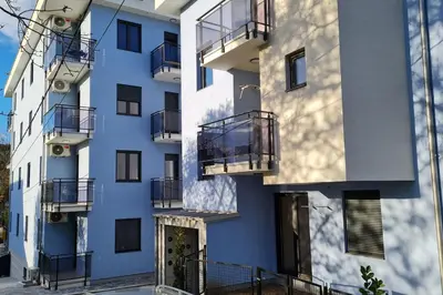 a blue building with balconies on the side of it at Apartman S16 Vrnjačka Banja in Vrnjačka Banja
