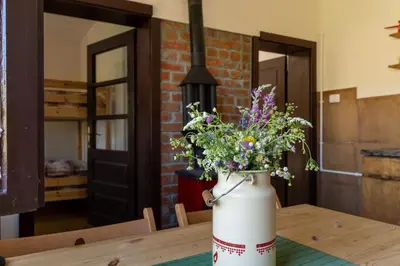 a vase filled with flowers sitting on a table at Mir i planina in Bučje