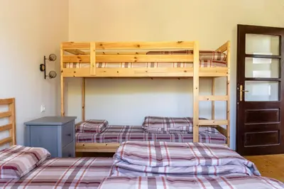 a bedroom with three bunk beds in a room at Mir i planina in Bučje
