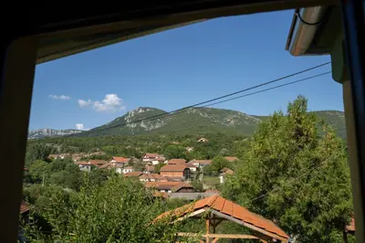 a view from a window of a town with mountains at Mir i planina in Bučje