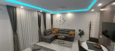a living room with a couch and a tv at GOLD APARTMANI in Prokuplje