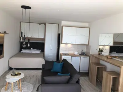 a living room with a couch and a bed at Cozy Mountain View Apartment in Kopaonik