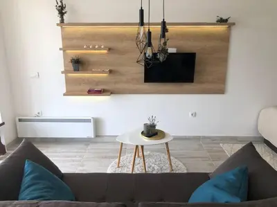 a living room with a couch and a table at Cozy Mountain View Apartment in Kopaonik