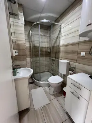 a bathroom with a shower and a toilet and a sink at Apartman Sita in Vrnjačka Banja