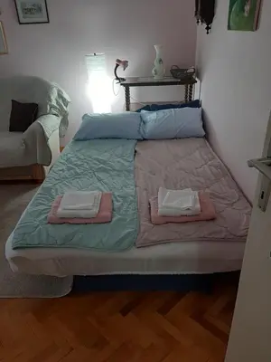 a bed in a room with two towels on it at Apartman Oskar in Bor