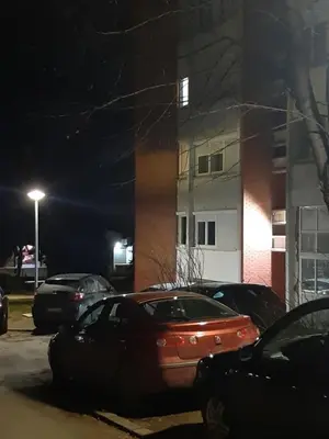 a car parked in front of a building at night at Apartman Oskar in Bor