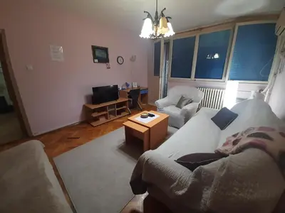 a living room with a couch and a table at Apartman Oskar in Bor