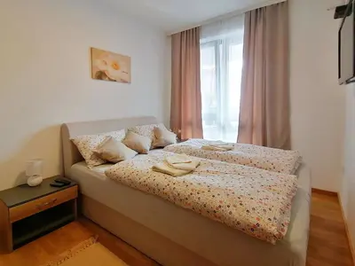 a bedroom with a bed with two towels on it at Apartman Andjelkovic in Soko Banja