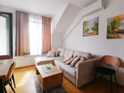a living room with a couch and a table at Apartman Andjelkovic in Soko Banja